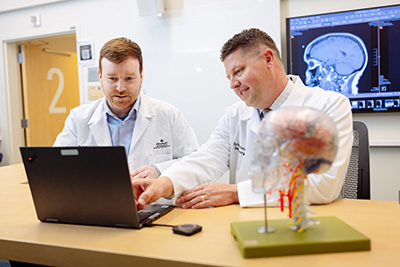 Neurosurgical team members discussing brain scans
