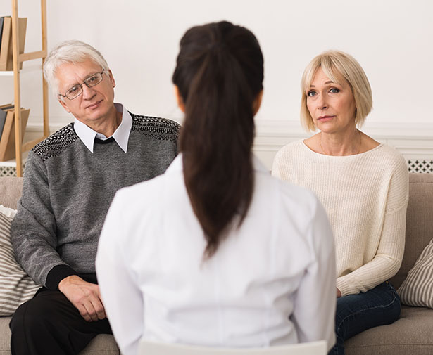 A couple discusses hospice care with a provider.