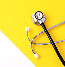 An image of a stethoscope on a yellow background